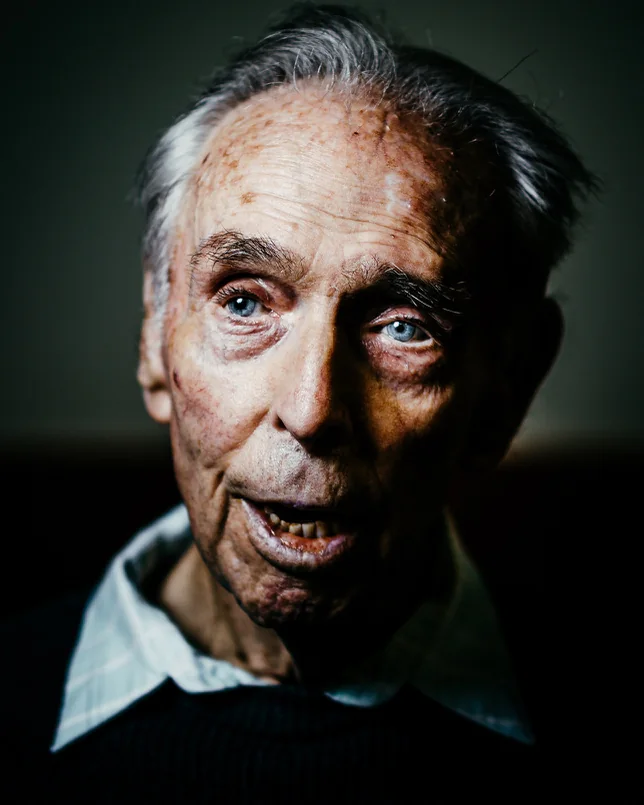 An elderly man with blue eyes