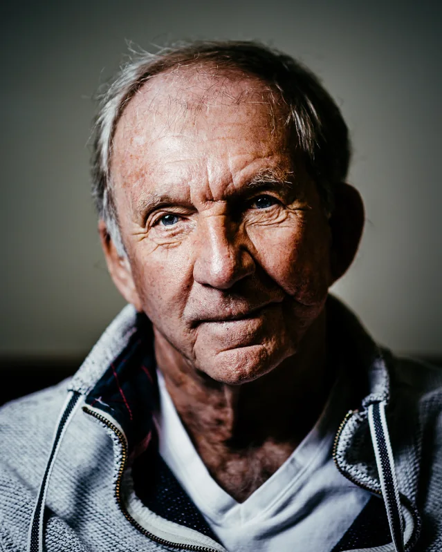 A man in a grey jacket, directional light